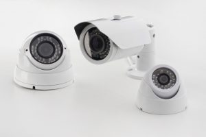 Bullet style and dome secure camera on light background, surveillance cameras.
