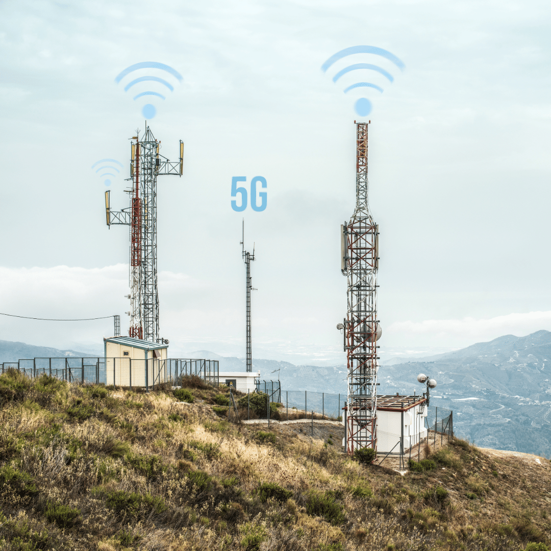 5G cell towers on a hillside with digital icons indicating wireless signal transmission, representing modern 5G network infrastructure