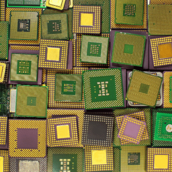 close-up of assorted semiconductor chips and processors arranged together, showing detailed circuitry and gold contact patterns, representing the global microchip and semiconductor industry